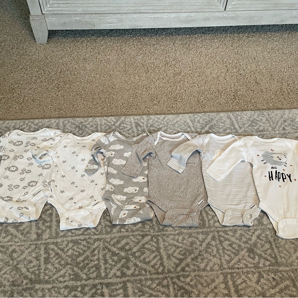 Six long sleeve sheep onesies by Gerber in a size 0-3 months